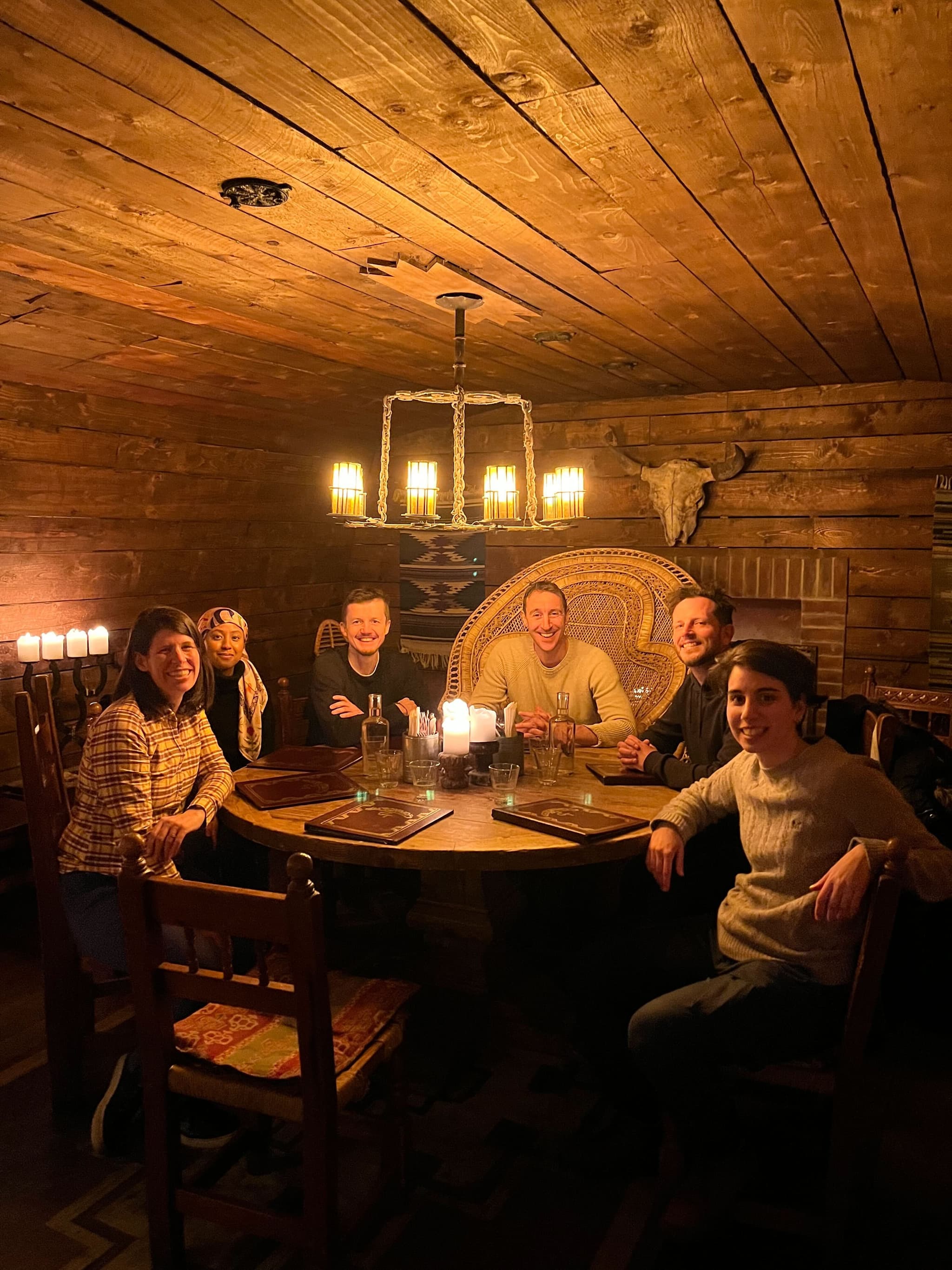 Team around a wooden table in a cabin